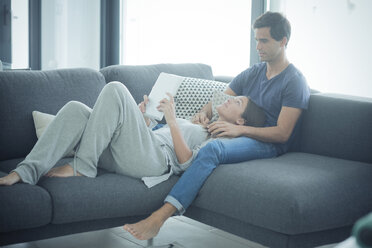 Young couple with tablet relaxing at home - SIPF01547