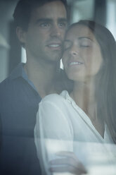 Young couple in love behind windowpane - SIPF01574