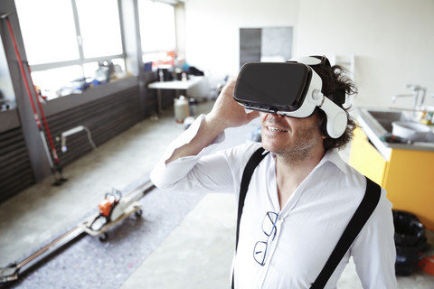Architect wearing Virtual Reality Glasses at construction site stock photo