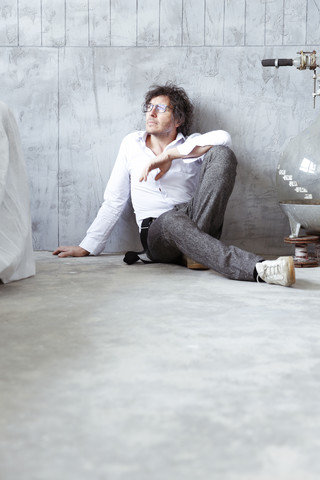 Architect sitting on the floor at construction site stock photo