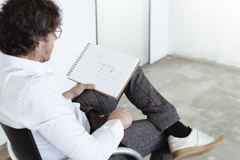 Architect sketching at construction site stock photo