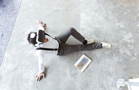 Architect using Virtual Reality Glasses at construction site stock photo