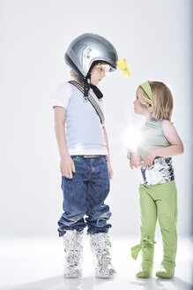 Boy dressed up as spaceman getting in contact with girl dressed up as alien - FSF00819