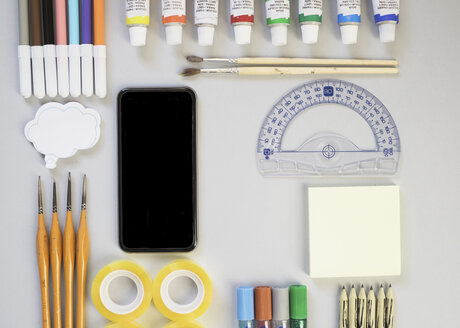 Top view of smartphone, protractor and artist's supplies - MOMF00033