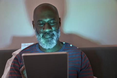 Mature man using digital tablet stock photo