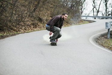 Man skating down the road - MOMF00052