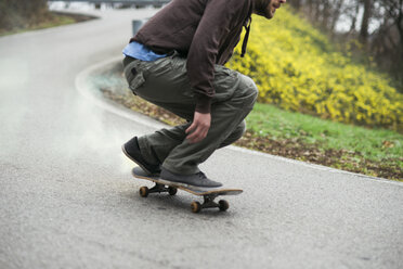 Man skating down the road - MOMF00053