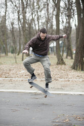 Skateboarder doing a trick - MOMF00054
