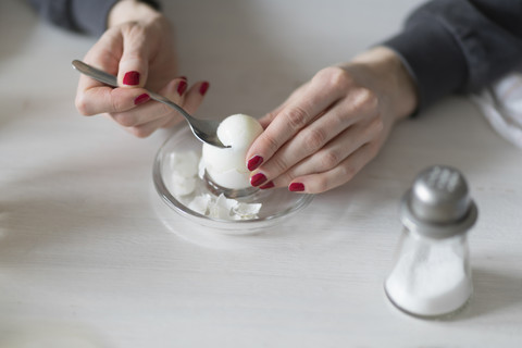 Close-up of woman eating boiled egg stock photo