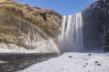 Iceland, Skogafoss waterfall with rainbow in winter - MELF00178