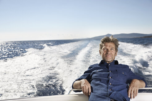 Portrait of content mature man on his motor yacht - PDF01094