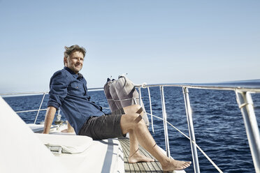 Relaxed mature man sitting on his motor yacht - PDF01115