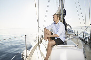 Smiling mature man relaxing on his sailing boat - PDF01160