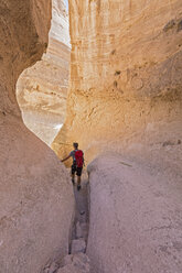 USA, New Mexico, Pajarito Plateau, Sandoval County, Kasha-Katuwe Tent Rocks National Monument, tourist in slot canyon - FOF09188