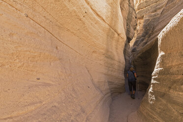 USA, New Mexico, Pajarito Plateau, Sandoval County, Kasha-Katuwe Tent Rocks National Monument, tourist in slot canyon - FOF09192