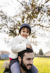 Portrait of happy little girl on shoulders of her father - MGOF03206