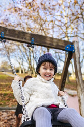 Portrait of happy little girl on a swing - MGOF03210