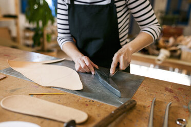 Close-up of shoemaker working on template in her workshop - VABF01303