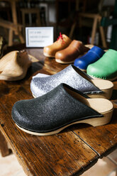 Assortment of clogs on table - VABF01324