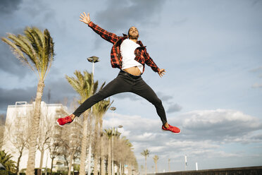 Spain, young man jumping in the air - JRFF01295