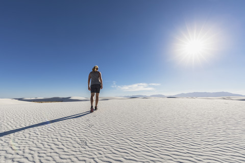 USA, New Mexico, Chihuahua-Wüste, White Sands National Monument, Frau wandert auf Düne, lizenzfreies Stockfoto