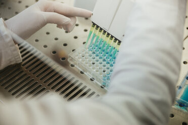 Close-up of laboratory technician pipetting in lab - ZEDF00570