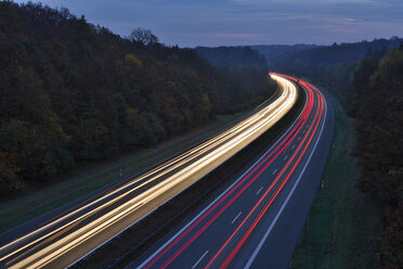 Germany, Bavaria, Traffic light trails on motorway at twilight - RUEF01783