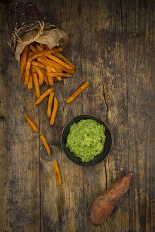 Süßkartoffelpommes und Avocado-Dip auf Holz - LVF06021