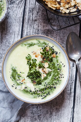 Bowl of spinach potato soup with roasted almonds - SBDF03168