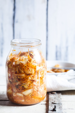 Glass of homemade Korean Kimchi with chinese cabbage, scallions and carrots stock photo