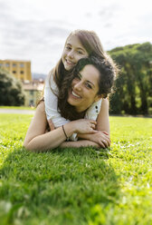 Mother and daughter having fun lying in the grass - MGOF03224