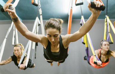 Group of women having a class of aerial yoga - MGOF03254