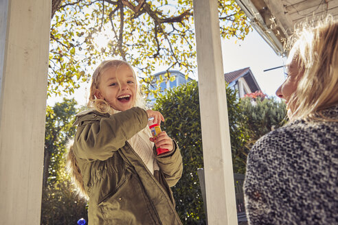 Happy girl with mother in garden - KDF00720