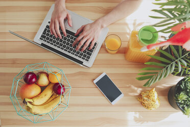 Top view of man using laptop at home - RTBF00829