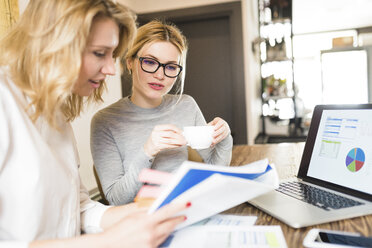 Two businesswomen working together on project - FMOF00192