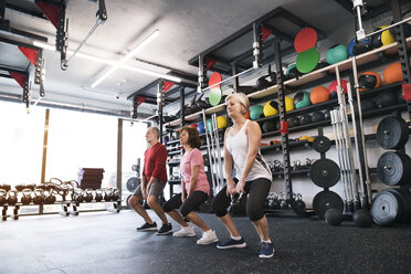 Group of fit seniors in gym working out with kettlebells - HAPF01484