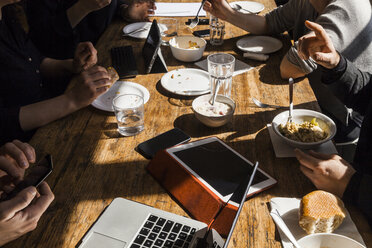 Colleagues having lunch together in the office, partial view - TCF05368