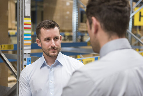 Two men in factory warehouse - DIGF01735