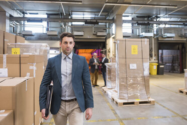 Three men in factory warehouse - DIGF01748