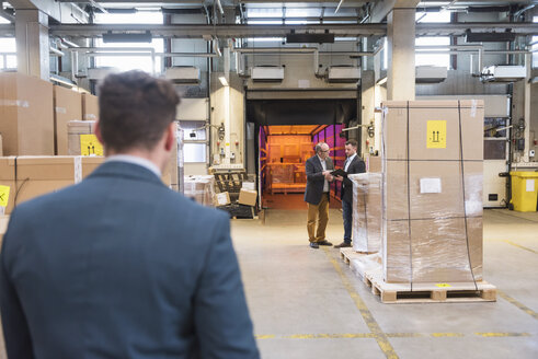 Three men in factory warehouse - DIGF01749