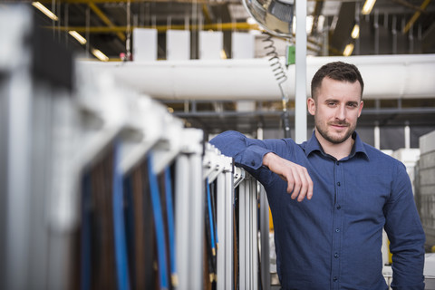Portrait of confident businessman in factory shop floor stock photo
