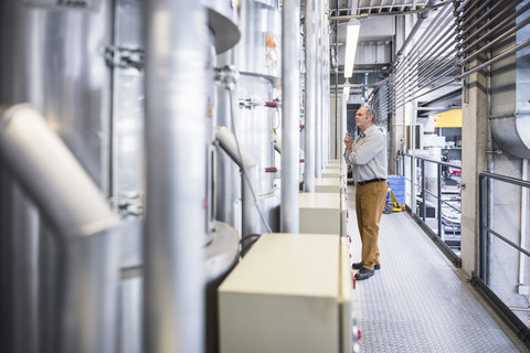 Man examining the system in factory stock photo