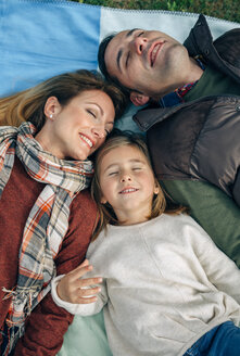 Happy family lying on blanket with closed eyes - DAPF00700