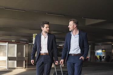 Two businessmen with rolling suitcase at bus terminal - DIGF01979