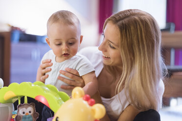 Mother and baby son playing with toys - DIGF01989