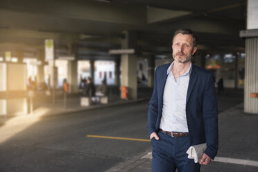 Portrait of mature businessman waiting at bus terminal - DIGF01997