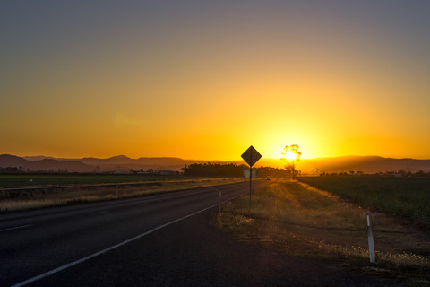 Australia, Queensland, landscape near Mackay, road at sunset stock photo