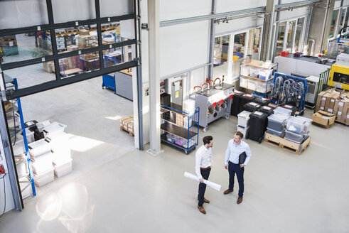Two businessmen talking in factory shop floor - DIGF02086