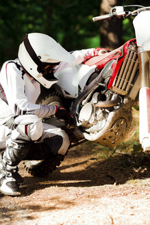 Italien, Motocross-Fahrer bei der Kontrolle seines Motorrads - FMOF00224