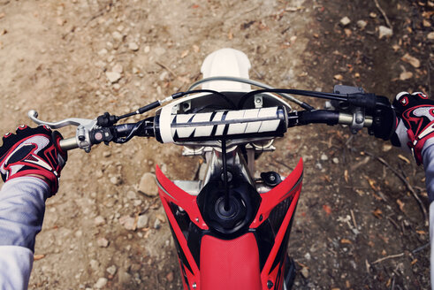 Bilker holding handlebar of his motor bike, close up - FMOF00231